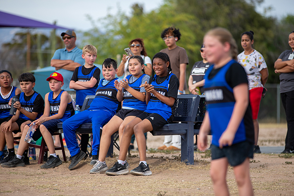 The Dunham kickball team sits on the sidelines